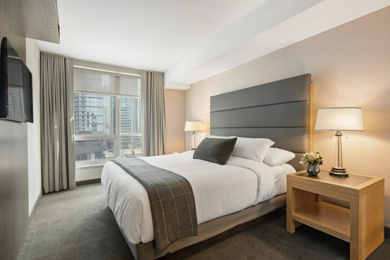 A softly lit bedroom with a neatly made bed